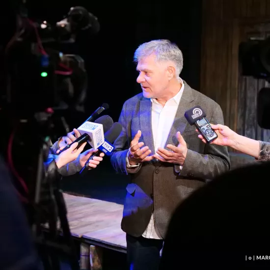 Zdjęcie z próby medialnej spektaklu „Zamiana". Na zdjęciu reżyser spektaklu Marek Pasieczny udziela wywiadu dziennikarzom. 