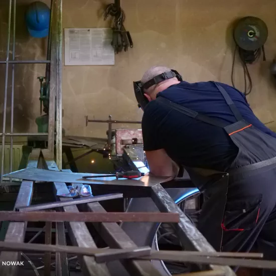 przygotowania do premiery „Świętoszka", ślusarnia. Na zdjęciu pracownik spawający metalowe elementy scenografii, fot. Marcin Nowak